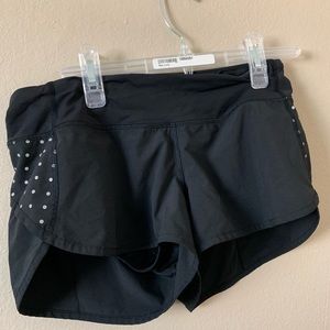 Black athletic shorts with reflective polka dots